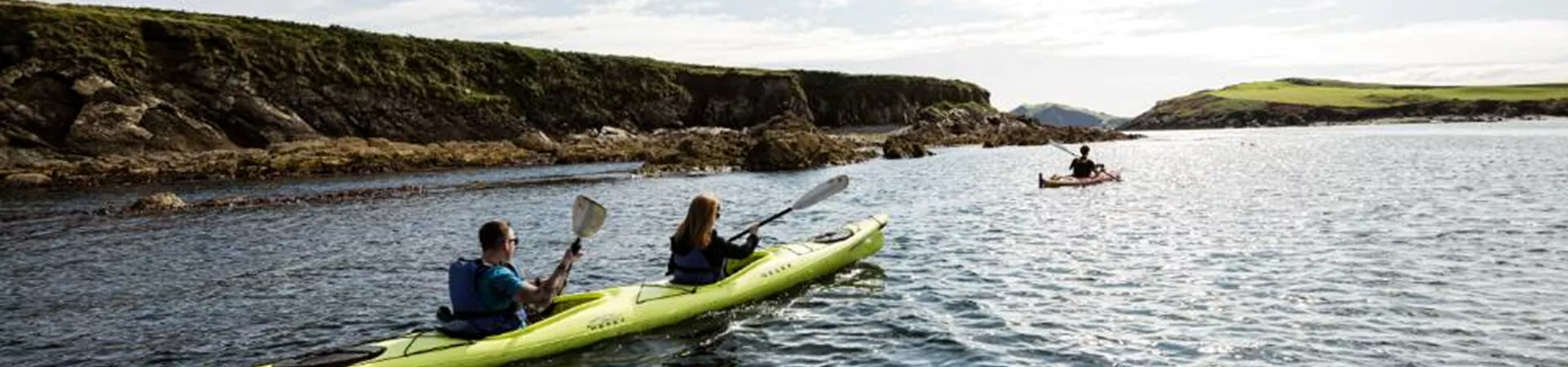 Travellers kayaking on Castlehaven Bay
