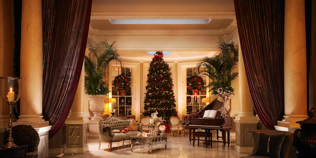 Christmas themed foyer of hotel with a huge christmas tree